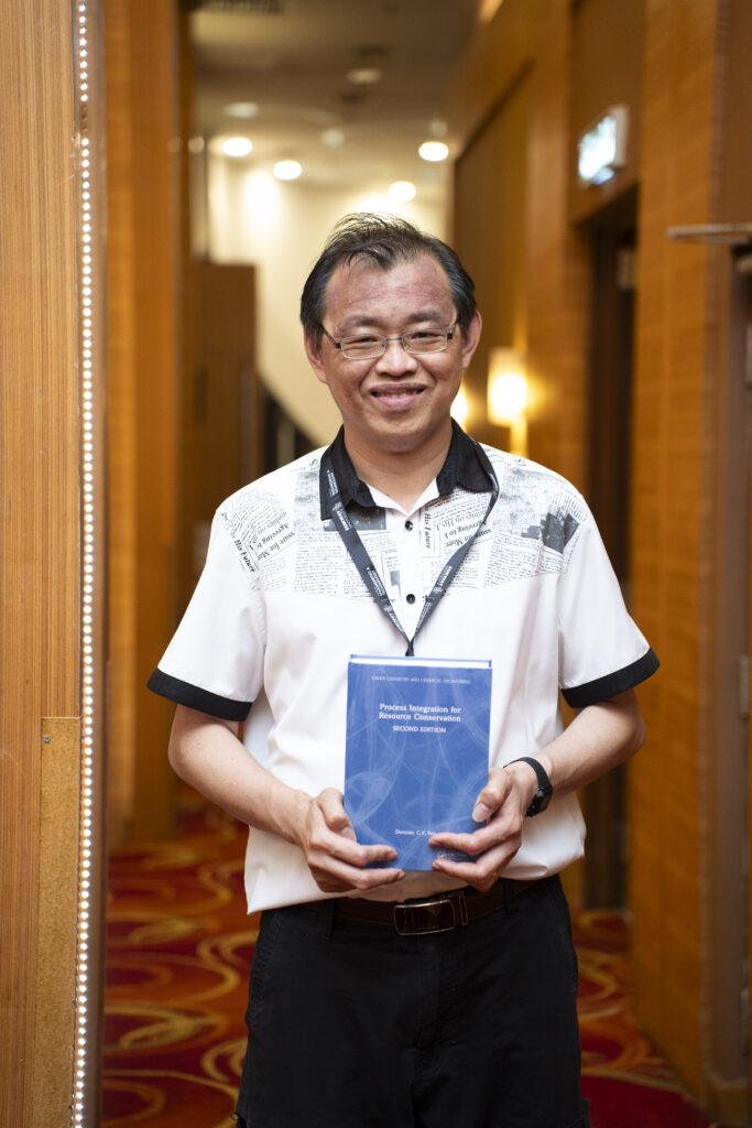 Dominic Foo posing with the book